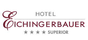 Goldenes ovales Logo mit schwarzem Schriftzug von Imlauer Hotels und Restaurants